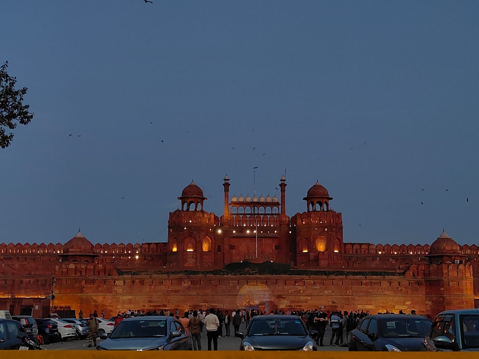 The Red Fort glowing red beneath a muted blue evening sky